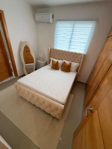 a bedroom with a large bed with two pillows on it at Oasis in San Isidro