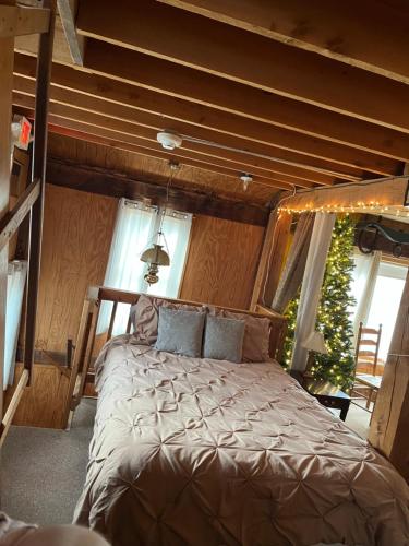 a bedroom with a bed in a room with a christmas tree at The Greenfield Inn in Greenfield