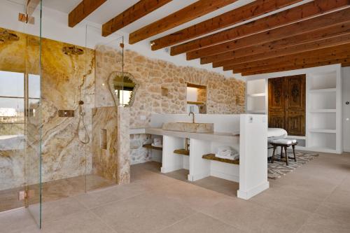 a bathroom with a sink and a shower at Mansión Santa María in Santa Maria del Camí
