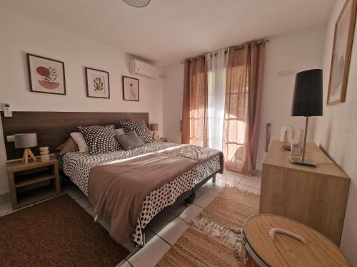 a bedroom with a bed and a window at L'oasis bleu in Cerbère