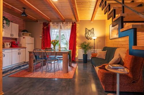 a living room with a couch and a table at Osada u Beatki - Strefa SPA in Lutowiska