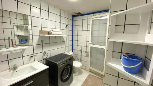 a bathroom with a sink and a washing machine at RESIDENCE OUARZAZATE in Ouarzazate