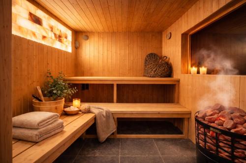 a sauna with a bench and a fire in it at Osada u Beatki - Strefa SPA in Lutowiska