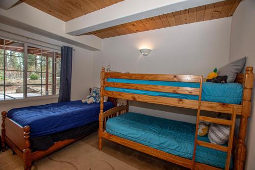 two bunk beds in a room with a window at Trailside Escape By Hauserman Rentals in Tahoe City