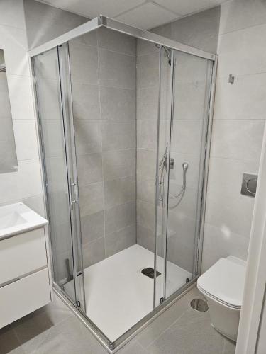a shower stall in a bathroom with a toilet at Flamenca Village Resort apt 455 in Orihuela Costa