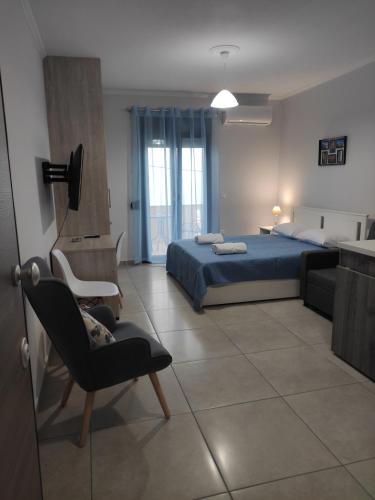 a bedroom with a bed and a chair at Varkaris Room 2 in Katarráktis