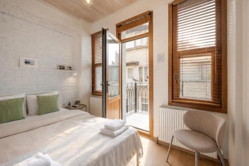 a white bedroom with a bed and a window at Private House Istanbul OldCity in Istanbul