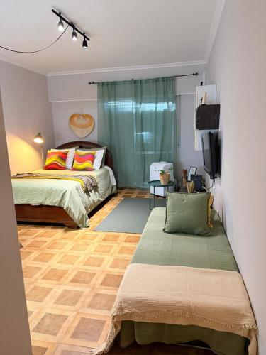 a bedroom with two beds and a tv in it at Studio Central na Amadora, Vista da Cidade, Sossegado, a 15min de Lisboa in Amadora