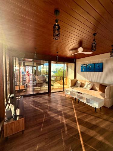 a living room with a couch and a table at Seaside Drift in Huraa