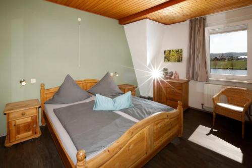 a bedroom with a wooden bed with blue pillows at Apartment MOSELGARTEN - Domherren-Suite in Piesport