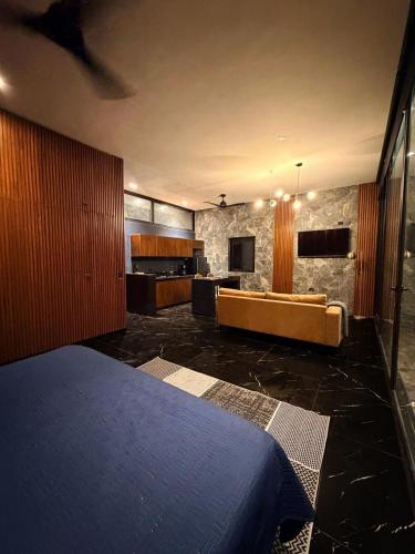 a bedroom with a bed and a couch in a room at Deluxe loft with direct access to the lagoon in Momoxpan