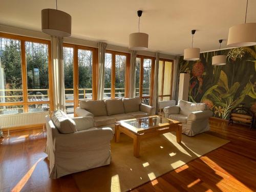 a living room with two couches and a coffee table at WILLA BOHEMA in Łagów