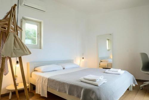 a bedroom with a bed with two towels on it at Blue & Earth Kea in Ioulis