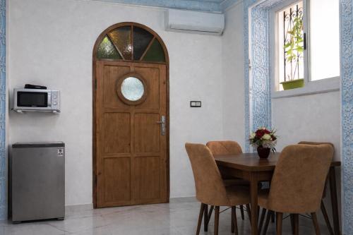 a wooden door in a room with a table and chairs at Tangier city center 1 in Tangier