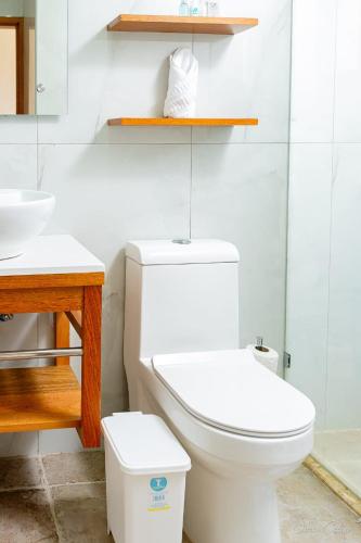 a bathroom with a white toilet and a sink at Stars Hotel Bavaro in Punta Cana