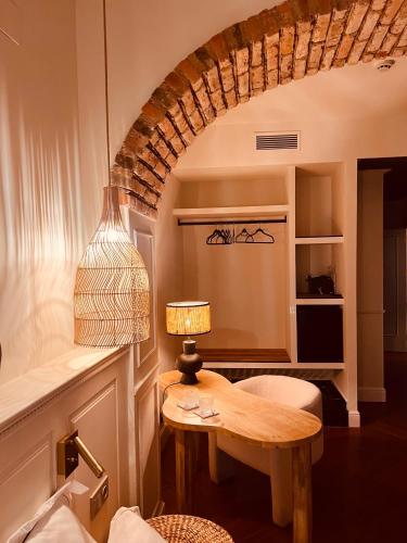 a living room with a table and a lamp at Hotel Villa Ruy López in Zafra