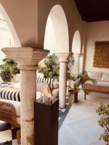 a living room with two columns and a table at Hotel Villa Ruy López in Zafra