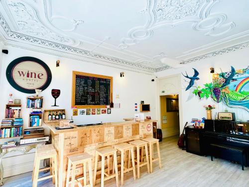 a restaurant with a bar with chairs and a piano at Porto Wine Hostel in Porto