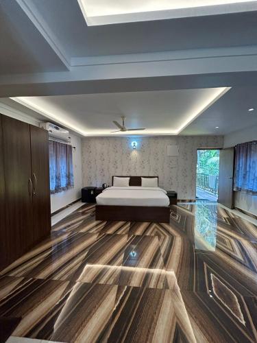 a bedroom with a bed and wooden floors at Marshmallow - by MA Homes in Morjim