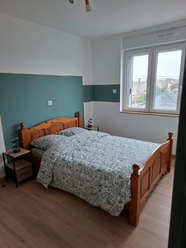 a bedroom with a large bed and a window at horizon doux in Calais