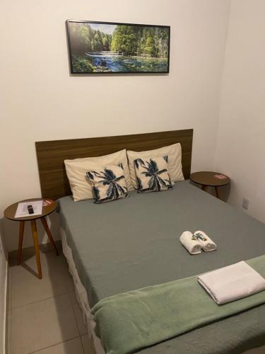 a bedroom with a bed with two pillows at Vale do Pontal Angra Suites in Angra dos Reis