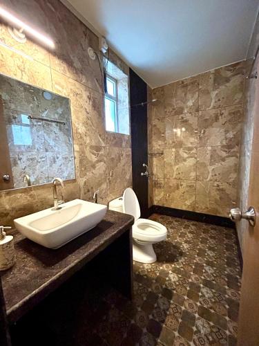 a bathroom with a sink and a toilet in it at Marshmallow - by MA Homes in Morjim