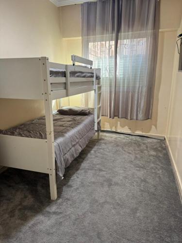 a bedroom with two bunk beds and a window at Apparemment à louer in Derroua