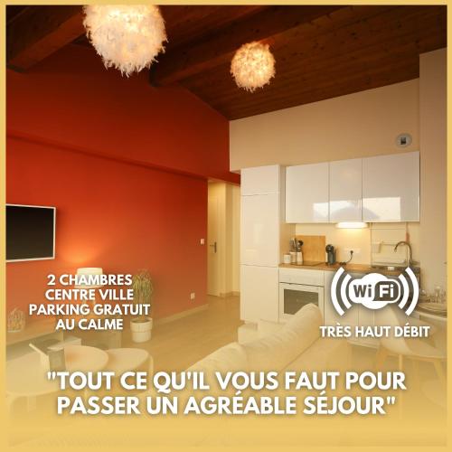 a kitchen with orange walls and white cabinets at Appartement le cocon de terre in Ambérieu-en-Bugey