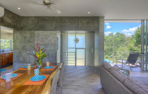 a living room with a table and a couch at Villa Los Laureles III, Private Pool, Nature Trails, Beaches in Esterillos Este