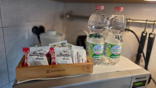 two bottles of water sitting on top of a refrigerator at Loft@Lounge in Grado-Pineta