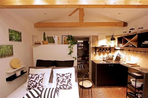 a room with a bed and a kitchen in it at Apartments Barbara in Lovran