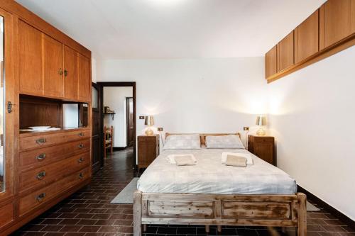 a bedroom with a large bed and wooden cabinets at Chalet Niki BELLAGIO in Bellagio