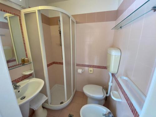a bathroom with a shower and a toilet and a sink at Hotel HARRY'S Hospitality Riccione-Fronte Mare in Riccione