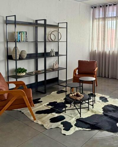 a living room with a couch and a chair at ALVORADA PALACE HOTEL in Bauru
