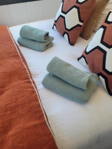 a bed with two green socks and a football pillow at Au Coin du Chêne in Thaon-les-Vosges