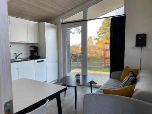 a living room with a couch and a table at DCU-Camping Kulhuse in Kulhuse