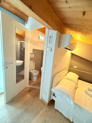 a small bedroom with a bed and a bathroom at Suite Aura Marina in Civitanova Marche