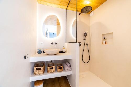 a bathroom with a sink and a mirror at Small house with swimming pool and jacuzzi in Biarritz