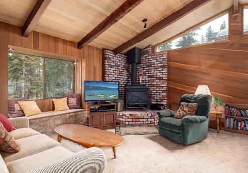 a living room with couches and a fireplace and a television at Villa Bossi in Carnelian Bay