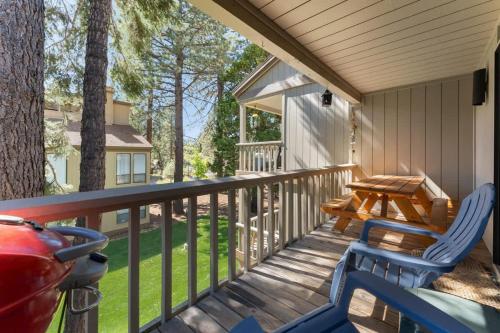 a porch with two chairs and a picnic table at Twisted Retreat in Kings Beach