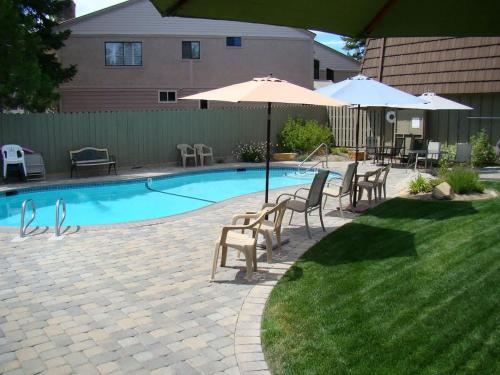 a swimming pool with chairs and umbrellas next to at Beach-N-Ski Condo in Tahoe Vista
