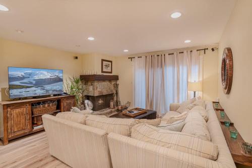 a living room with a large couch and a television at Beach-N-Ski Condo in Tahoe Vista