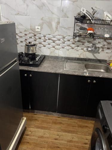 a kitchen with a stove and a counter top at Dar yasmine in Azrou