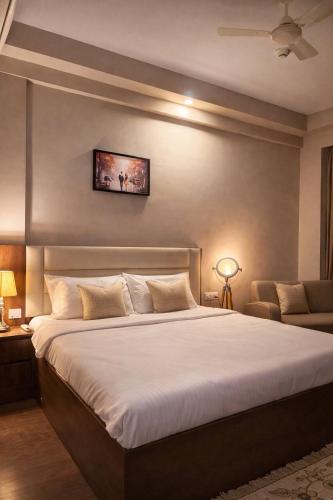 a bedroom with a large white bed in a room at StayScape studio in Greater Noida