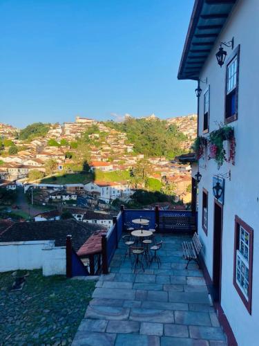 a patio with a table and chairs on a building at Pousada Ouro Preto in Ouro Preto