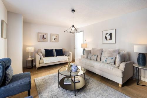 a living room with a couch and a table at 10 Mins Walk to The Oval, The Kennington Retreat in London