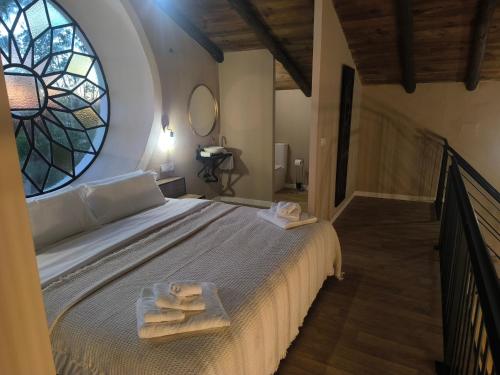 a bedroom with a bed with two towels on it at Hacienda La Celada CARMONA SEVILLA in La Celada