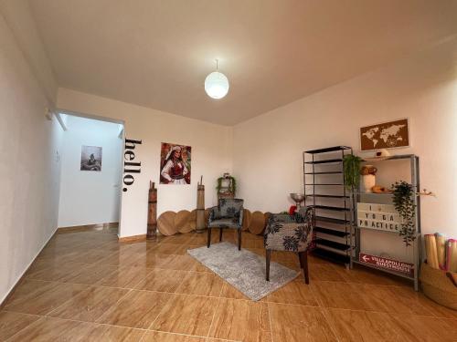 a living room with two chairs and a table at Villa Apollonia Guest House in Fier