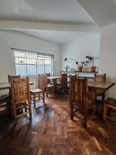 a dining room with wooden tables and chairs at York Hostel in La Paz