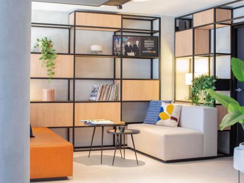 a living room with a couch and a table at ibis Nice Aéroport Promenade des Anglais in Nice